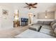 Cozy living room featuring plush gray furniture, ceiling fan, and a unique aquarium at 7815 Conifer Rd, Denver, CO 80221