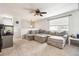 Bright living room featuring a large, comfortable gray sectional sofa and ceiling fan, perfect for relaxation at 7815 Conifer Rd, Denver, CO 80221