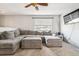 Comfortable living room with a large gray sectional, plush carpeting, and a window with natural light at 7815 Conifer Rd, Denver, CO 80221