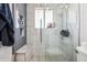 This glass enclosed shower offers built-in storage and sleek tile at 7815 Conifer Rd, Denver, CO 80221