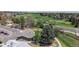 Aerial view of a home near a golf course in a neighborhood; with well-manicured lawns and mature trees at 39 S Scott Dr, Broomfield, CO 80020