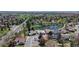 An aerial view of the home, showing the nearby pond and park with mature trees and landscaping at 39 S Scott Dr, Broomfield, CO 80020