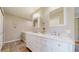 Bright bathroom featuring a white double vanity, tile floors, and neutral paint at 39 S Scott Dr, Broomfield, CO 80020