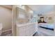 A bathroom with double vanity, and access to the main bedroom at 39 S Scott Dr, Broomfield, CO 80020