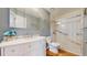 Modern bathroom with glass enclosed shower, white vanity, and tile flooring at 39 S Scott Dr, Broomfield, CO 80020
