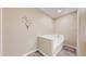 A tiled bathtub with a white surround, complemented by neutral walls at 39 S Scott Dr, Broomfield, CO 80020