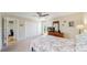 Bedroom with carpet flooring, TV on dresser, closet space, and access to other rooms at 39 S Scott Dr, Broomfield, CO 80020