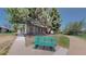Charming green bench nestled under mature trees along a walking path, ideal for relaxation at 39 S Scott Dr, Broomfield, CO 80020
