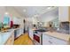 Modern kitchen with stainless steel appliances, stone backsplash, and hardwood floors at 39 S Scott Dr, Broomfield, CO 80020