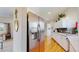 Stainless steel refrigerator in kitchen with white cabinets and hardwood floors at 39 S Scott Dr, Broomfield, CO 80020
