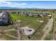 A high-angle view shows a neighborhood park featuring an enclosed dog run and walking paths at 437 Buckskin Rd, Berthoud, CO 80513