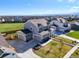 Expansive aerial view of a modern home with a spacious driveway and well-kept lawn at 437 Buckskin Rd, Berthoud, CO 80513