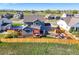 Aerial view of the home shows the outdoor living space with a fire pit, patio, and fenced yard at 437 Buckskin Rd, Berthoud, CO 80513