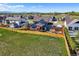Aerial view of the house, backyard with firepit, pergola, and mountain views beyond the fenced yard at 437 Buckskin Rd, Berthoud, CO 80513