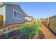 Landscaped backyard features a covered patio, lush lawn, wood fence, and is perfect for outdoor living at 437 Buckskin Rd, Berthoud, CO 80513