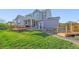 Spacious backyard with covered patio, deck, landscaping and water feature at 437 Buckskin Rd, Berthoud, CO 80513