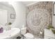 Cozy half-bathroom with patterned wall decor, a vanity, and a modern faucet at 437 Buckskin Rd, Berthoud, CO 80513