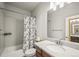 Bathroom with single sink vanity, mirror, and shower over tub at 437 Buckskin Rd, Berthoud, CO 80513