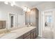 Bathroom with double sink vanity, wooden cabinets, a large mirror, and plenty of storage space at 437 Buckskin Rd, Berthoud, CO 80513