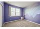Bedroom with a large window, neutral carpet and purple accent wall at 437 Buckskin Rd, Berthoud, CO 80513