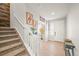 Bright entryway featuring hardwood floors, a staircase, and stylish decor at 437 Buckskin Rd, Berthoud, CO 80513
