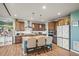 Bright kitchen with an island, wooden cabinetry, stainless steel appliances, and stylish countertops at 437 Buckskin Rd, Berthoud, CO 80513