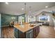Open-concept kitchen with modern island, dining area, and living room at 437 Buckskin Rd, Berthoud, CO 80513