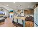 Open-concept kitchen featuring a kitchen island with bar seating, stainless steel appliances, and hardwood floors at 437 Buckskin Rd, Berthoud, CO 80513