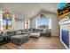 Spacious living room featuring a large sectional sofa, hardwood floors, natural light, and comfortable seating at 437 Buckskin Rd, Berthoud, CO 80513