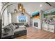 Cozy living room with vaulted ceilings, hardwood floors, fireplace, large sectional sofa, and natural light at 437 Buckskin Rd, Berthoud, CO 80513