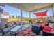 Relaxing covered patio with outdoor seating, a fire pit, and a stylish sunshade at 437 Buckskin Rd, Berthoud, CO 80513