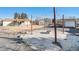 Gravel backyard featuring string lights around a fire pit area, patio area in the background at 6147 Dunraven, Golden, CO 80403