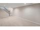 Open basement space features neutral walls, plush carpet and a stairway at 6147 Dunraven, Golden, CO 80403