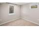 Carpeted basement space featuring bright, neutral paint and natural light from windows at 6147 Dunraven, Golden, CO 80403