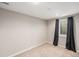 Finished basement with neutral carpeting and a window with blackout curtains at 6147 Dunraven, Golden, CO 80403