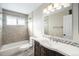 Updated bathroom featuring a soaking tub, modern vanity, and stylish tile work at 6147 Dunraven, Golden, CO 80403