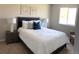 Comfortable bedroom with a plush bed, decorative pillows, and modern nightstands at 6147 Dunraven, Golden, CO 80403