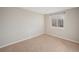 Bedroom featuring neutral walls, carpet flooring, and a bright window at 6147 Dunraven, Golden, CO 80403