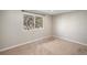 Cozy bedroom featuring neutral walls, carpet flooring, and a large window at 6147 Dunraven, Golden, CO 80403