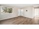 Bright living room featuring hardwood floors, a double door entry, and a large window at 6147 Dunraven, Golden, CO 80403