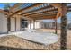 Covered patio area with modern wood covering and stone accents, door to home at 6147 Dunraven, Golden, CO 80403