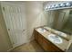 Bathroom featuring double sinks, a large mirror and tub shower at 10067 Idalia St, Commerce City, CO 80022