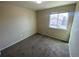 Carpeted bedroom with one large window that provides natural light and views of the neighborhood at 10067 Idalia St, Commerce City, CO 80022