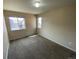 Bright bedroom featuring neutral walls, two windows, and carpet floors at 10067 Idalia St, Commerce City, CO 80022