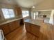 Kitchen with wood cabinets, wood flooring, and island at 10067 Idalia St, Commerce City, CO 80022