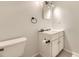 Bathroom featuring a vanity with sink, toilet, and towel holder at 4653 S Lowell Blvd # E, Denver, CO 80236
