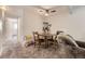 Dining area features a table with seating for two, ceiling fan, and carpeted flooring at 4653 S Lowell Blvd # E, Denver, CO 80236
