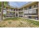 Multi-level condo building featuring balconies, brick accents, and well-maintained landscaping at 4653 S Lowell Blvd # E, Denver, CO 80236