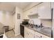 Galley kitchen with stainless steel sink, granite countertops and white cabinetry at 4653 S Lowell Blvd # E, Denver, CO 80236