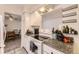 Bright kitchen features a range, overhead vent, white cabinets, and granite counters at 4653 S Lowell Blvd # E, Denver, CO 80236